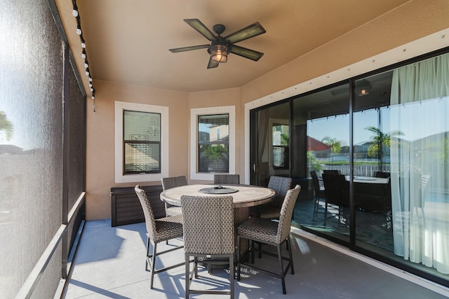 sunroom featuring ceiling fan