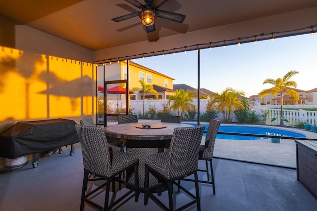 view of patio / terrace with a fenced in pool, grilling area, and ceiling fan