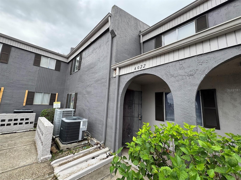 view of exterior entry featuring central AC unit