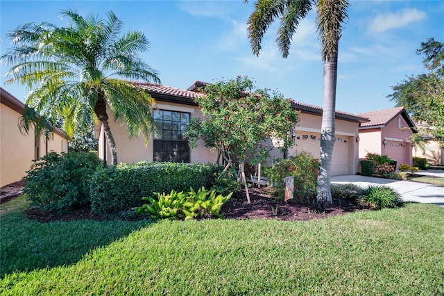 mediterranean / spanish-style house with a front lawn and a garage