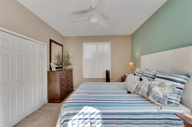 carpeted bedroom featuring a closet and ceiling fan