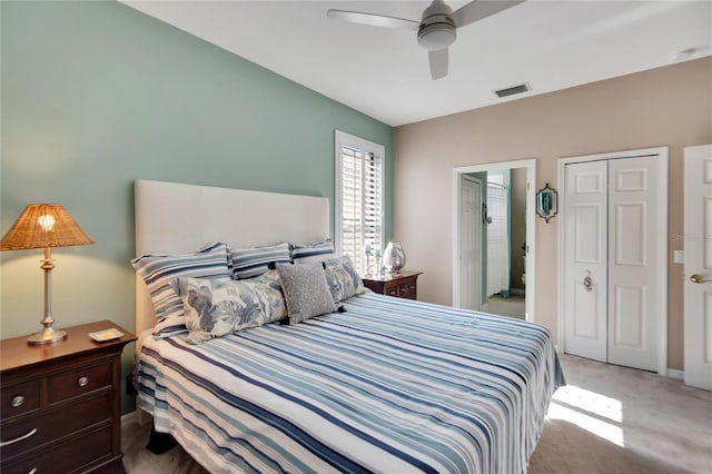 bedroom featuring ceiling fan, a closet, and light carpet