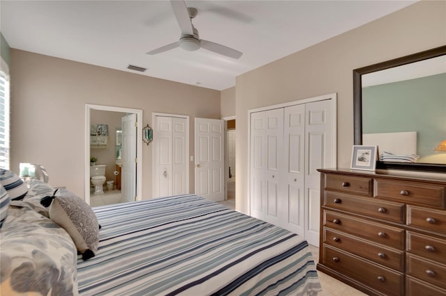 carpeted bedroom with ceiling fan, connected bathroom, and multiple closets