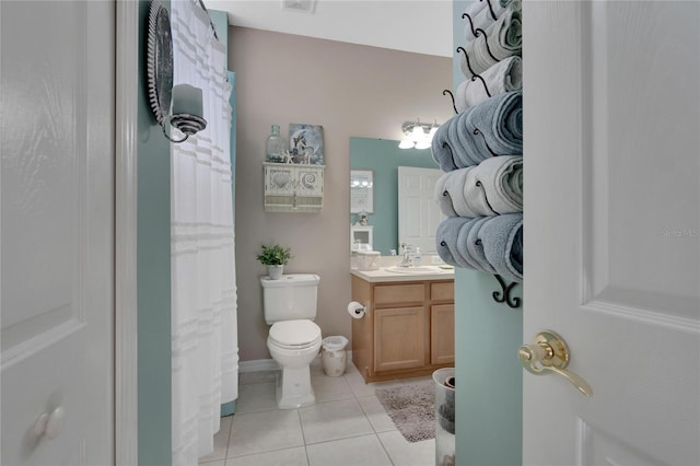 bathroom featuring tile patterned floors, vanity, curtained shower, and toilet