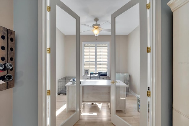 bathroom featuring ceiling fan and wood-type flooring