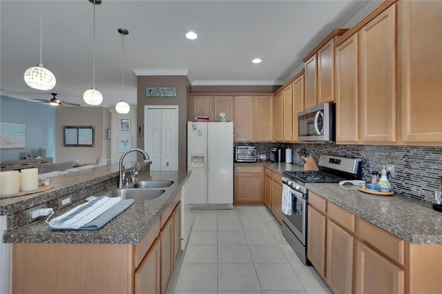 kitchen with ceiling fan, light brown cabinetry, stainless steel appliances, and hanging light fixtures