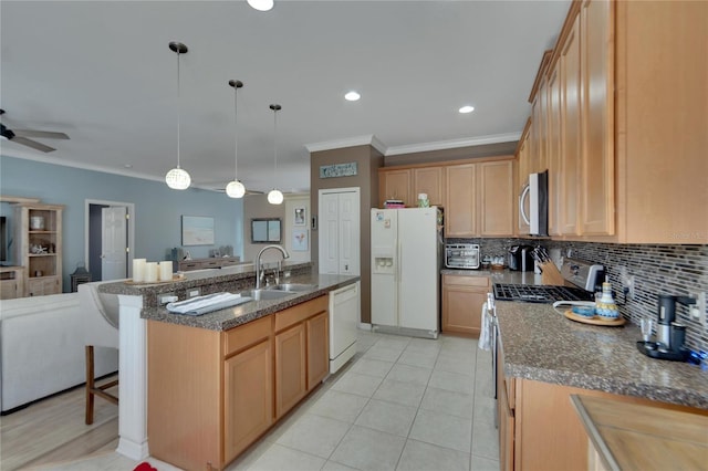 kitchen featuring ceiling fan, sink, decorative light fixtures, a center island with sink, and appliances with stainless steel finishes