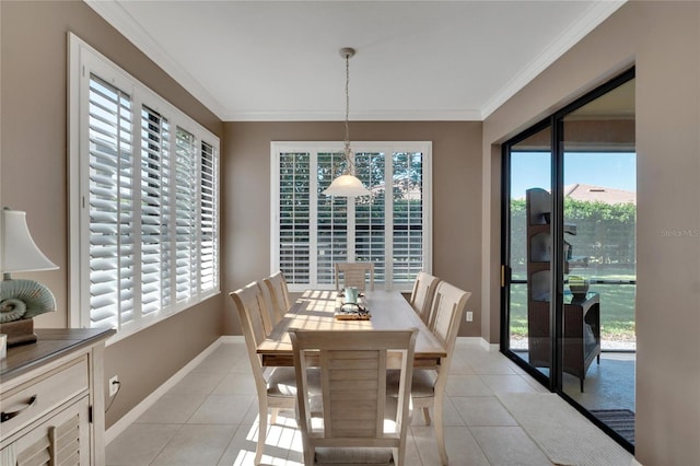 dining area with light tile patterned floors, a healthy amount of sunlight, and ornamental molding