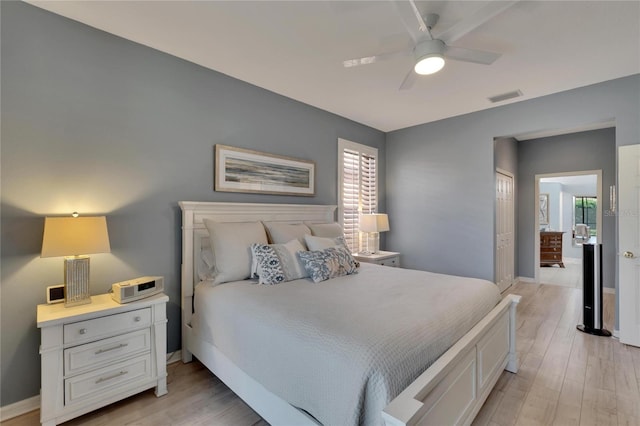 bedroom featuring light wood-type flooring, a closet, and ceiling fan