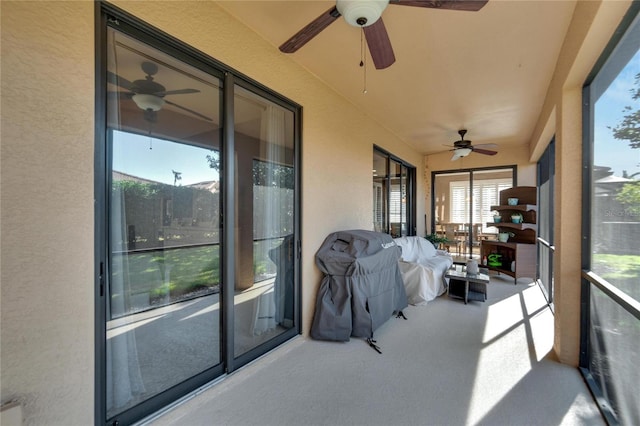 sunroom featuring ceiling fan