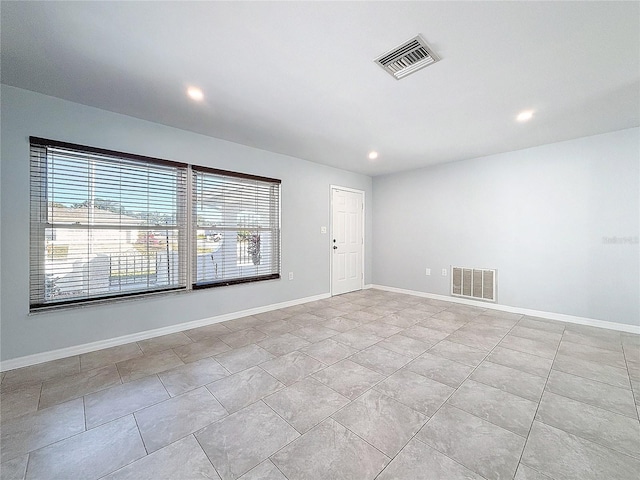 unfurnished room featuring light tile patterned floors