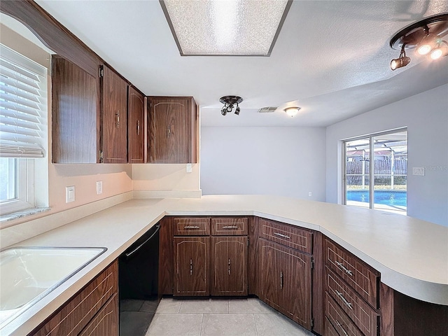 kitchen with dishwasher, sink, kitchen peninsula, a textured ceiling, and light tile patterned floors