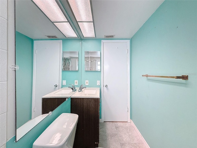 bathroom featuring tile patterned flooring and vanity