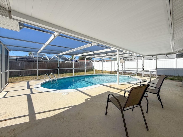 view of pool featuring glass enclosure and a patio area