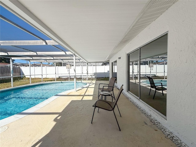 view of swimming pool with a patio and glass enclosure