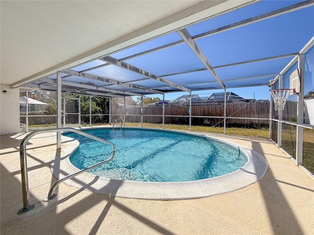 view of swimming pool featuring glass enclosure and a patio area