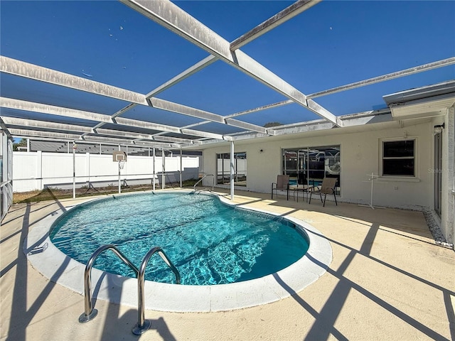 view of swimming pool featuring a patio and a lanai