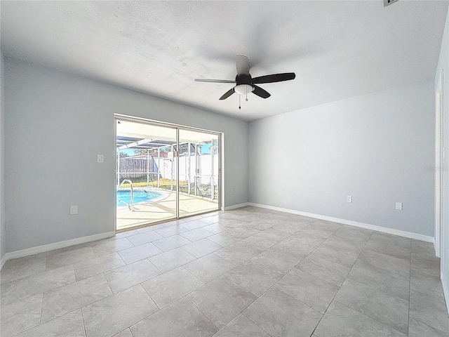 tiled empty room with ceiling fan