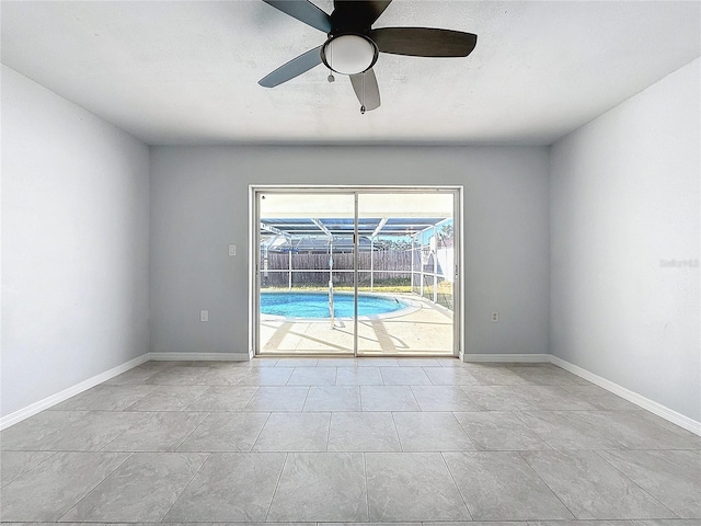 unfurnished room featuring ceiling fan and light tile patterned floors