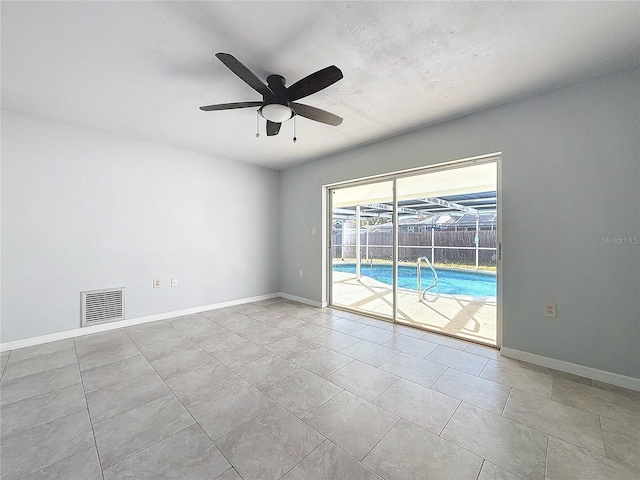 unfurnished room with ceiling fan and light tile patterned flooring