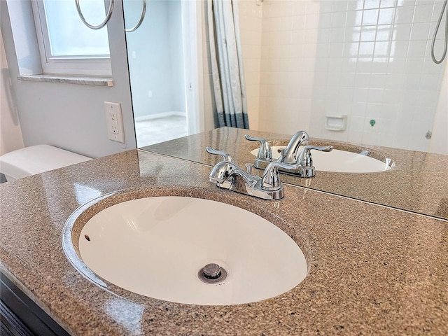 interior details featuring vanity and a shower with shower curtain