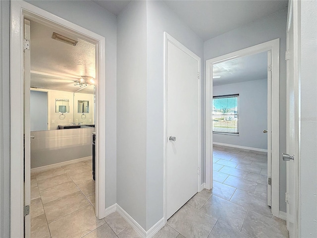 hallway with light tile patterned flooring