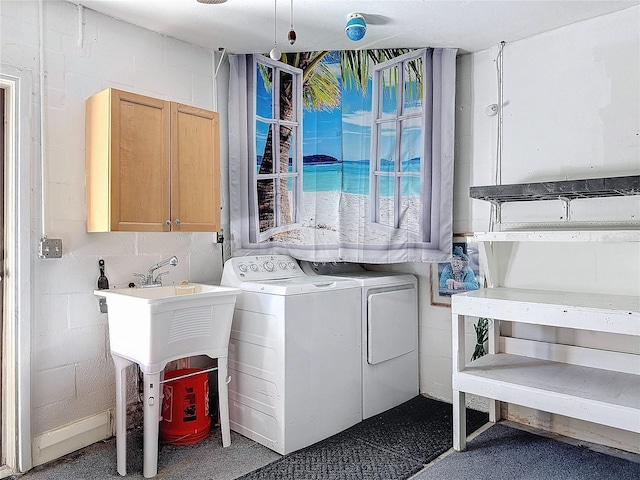 laundry area featuring washer and clothes dryer and cabinets