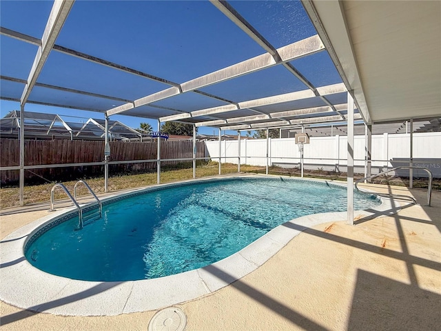 view of swimming pool featuring glass enclosure and a patio area