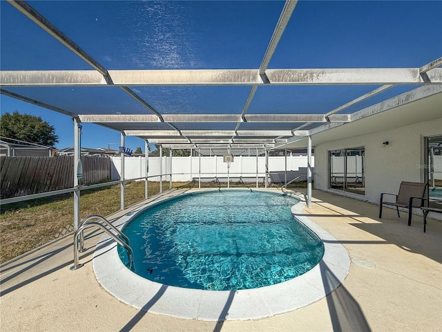 view of swimming pool featuring a lanai and a patio