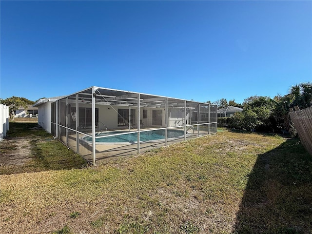 exterior space featuring a lanai and a lawn