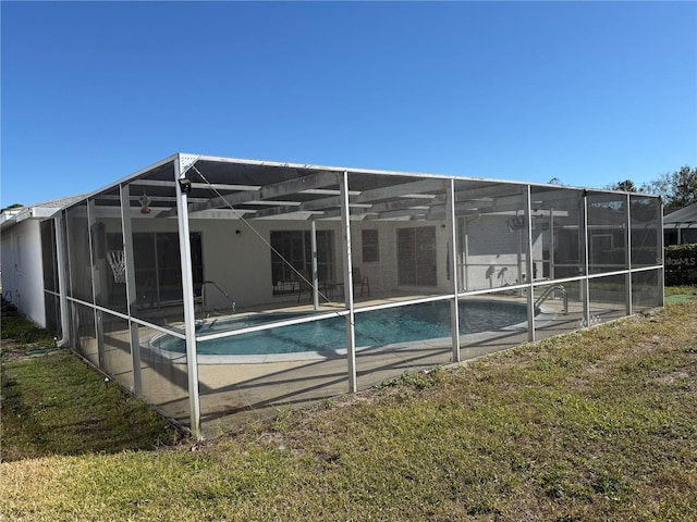 exterior space with a lanai and a yard