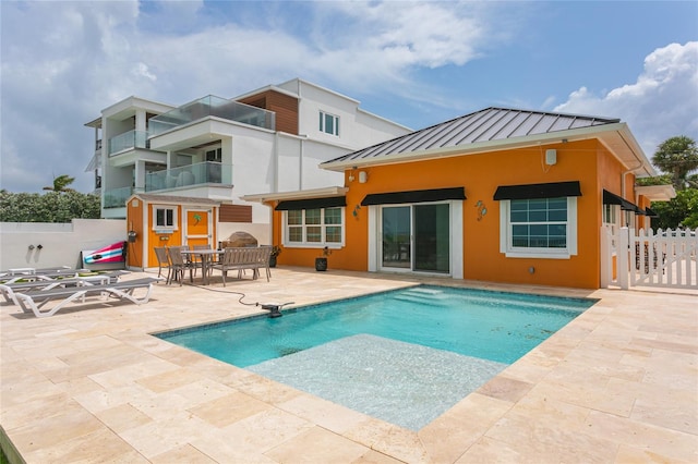 rear view of property featuring a patio area