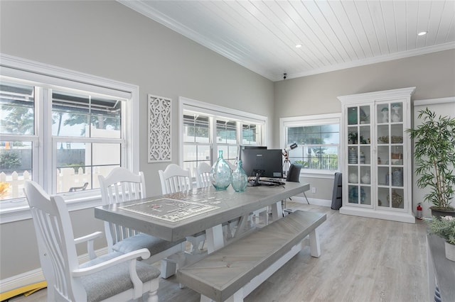 dining space featuring light hardwood / wood-style flooring, wooden ceiling, and crown molding