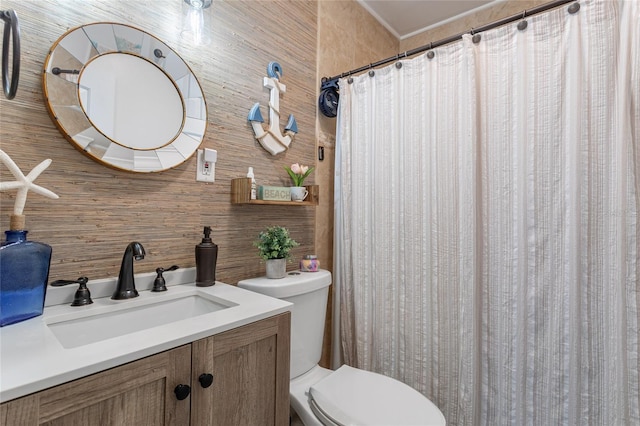 bathroom featuring wooden walls, vanity, and toilet