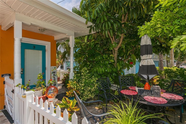 view of exterior entry featuring covered porch