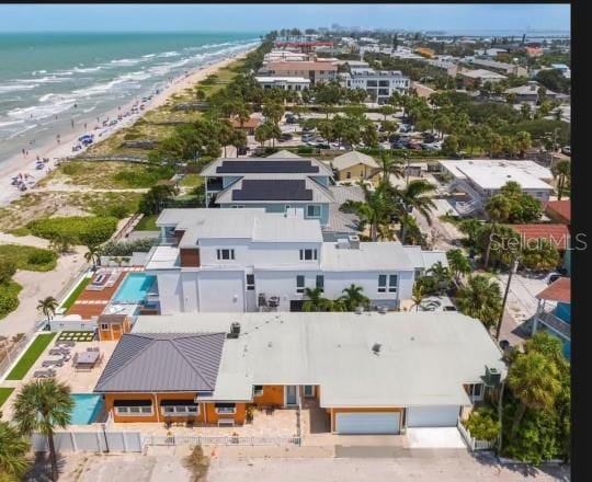 bird's eye view featuring a water view and a beach view