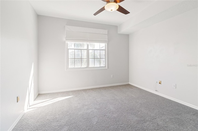 unfurnished room with ceiling fan and carpet