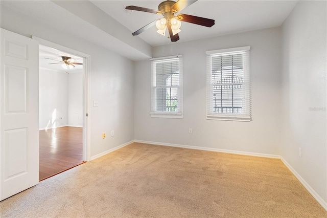 carpeted empty room featuring ceiling fan