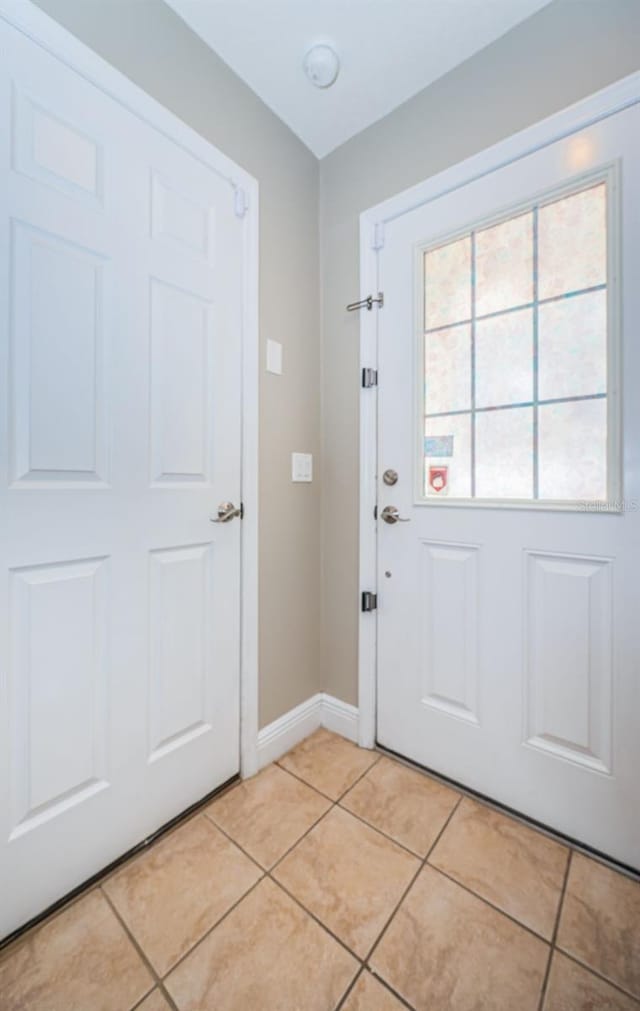 doorway with light tile patterned floors