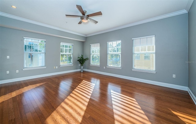 empty room featuring ceiling fan, dark hardwood / wood-style flooring, and crown molding