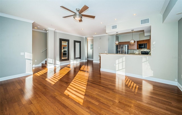 unfurnished living room featuring ornamental molding, ceiling fan, and dark wood-type flooring