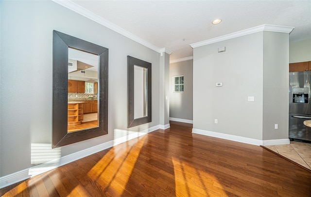 unfurnished room featuring hardwood / wood-style floors and ornamental molding