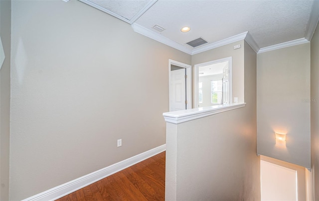 corridor featuring wood-type flooring and ornamental molding