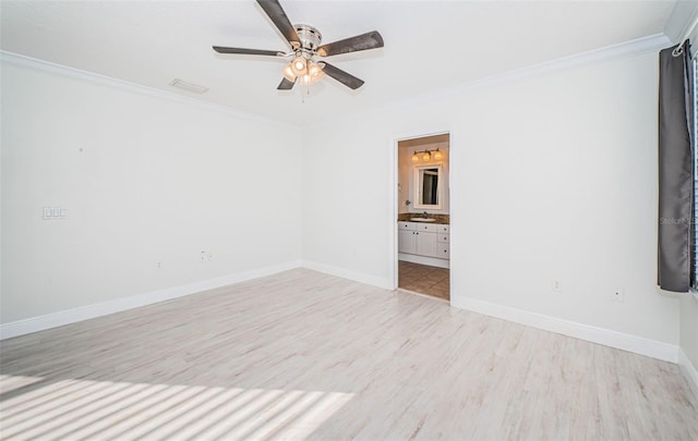 empty room with ceiling fan, ornamental molding, and light hardwood / wood-style flooring