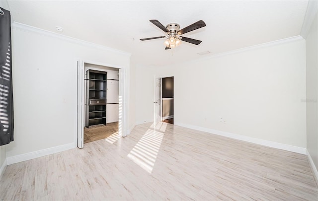 unfurnished room with ceiling fan, light wood-type flooring, and ornamental molding