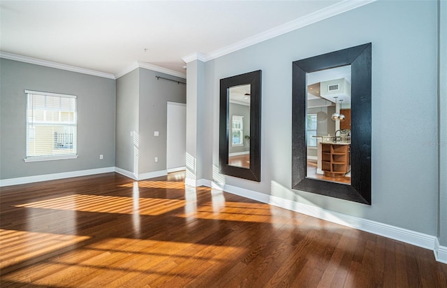 spare room featuring crown molding and wood-type flooring