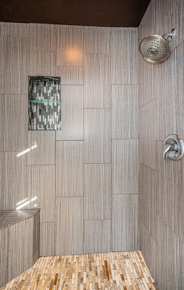 bathroom with a tile shower