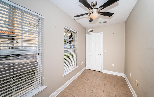 doorway featuring light tile patterned floors and a textured ceiling