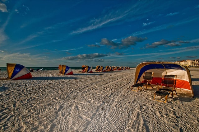 surrounding community featuring a beach view and a water view