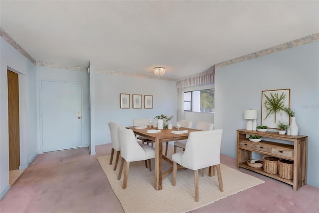 dining space featuring light carpet